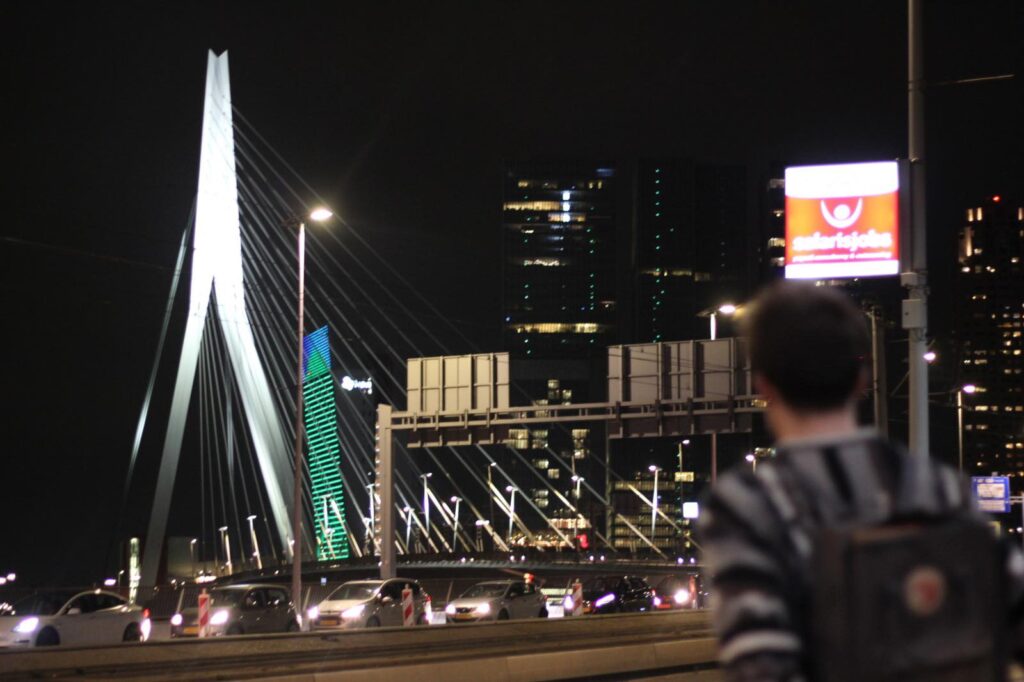Erasmus bridge with man standing in front