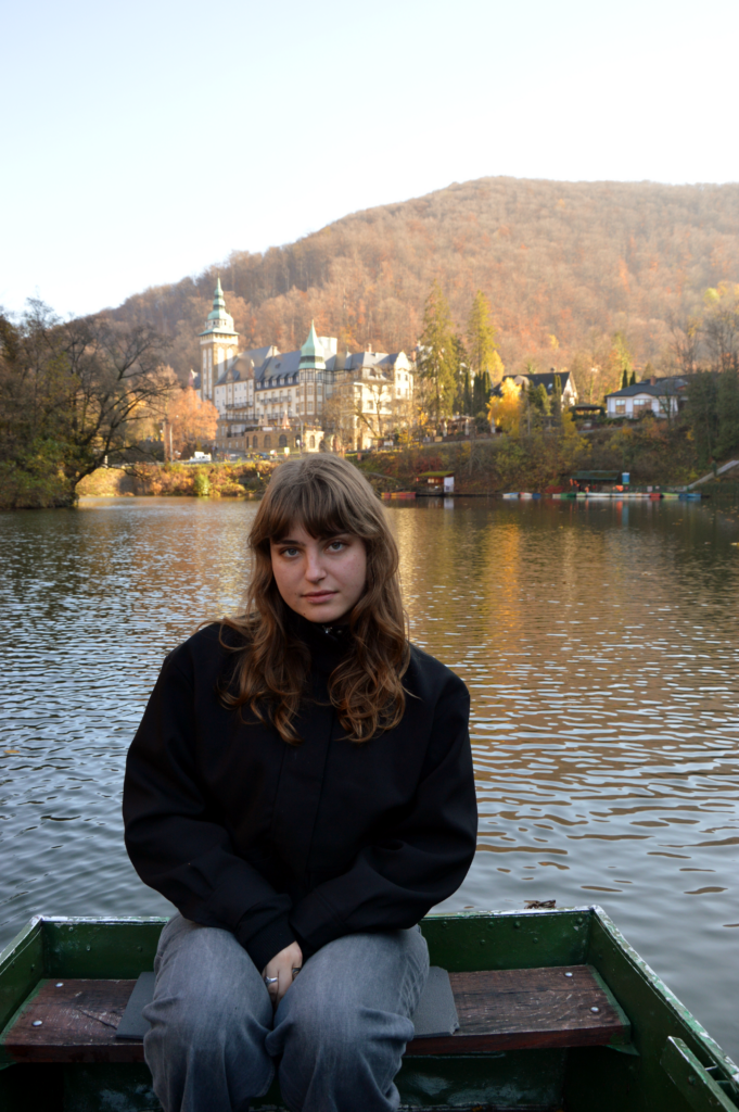 Woman sitting in a boat on a lake in Hungary.