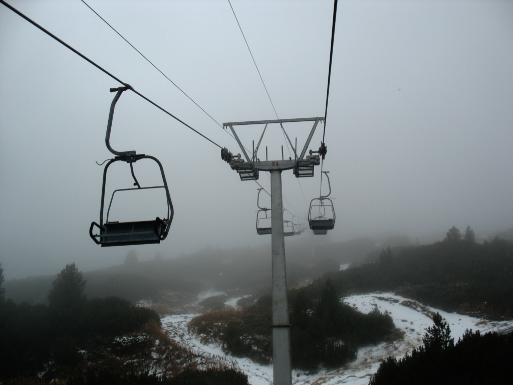 Empty ski lift chairs ascending the steep mountains of Rila in Bulgaria